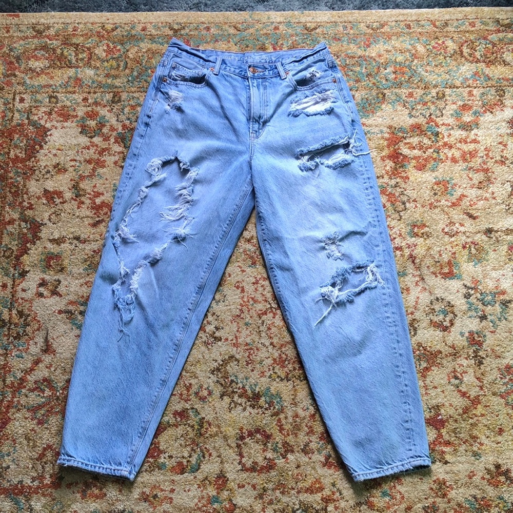 Distressed blue denim jeans